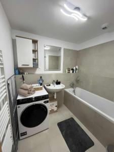 a bathroom with a sink and a washing machine at luxury apartment in Bratislava +53 photos