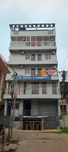 a tall white building with a sign on it at KR HOTEL AND BANQUET Hall in Dhanbād