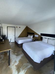a hotel room with two beds and a table at Southern Soho Boutique Hotel in Oxford +13 photos