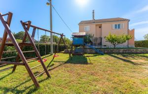 a playground in front of a house at 5 Bedroom Cozy Home In Biograd Na Moru in Biograd na Moru