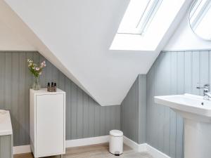 a bathroom with a sink and a skylight at Crofthouse - Uk43405 in Wigtown