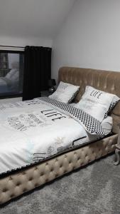 two beds with white blankets and pillows in a bedroom at la maison blanche a Hermeton sur Meuse in Hastière-par-delà +61 photos