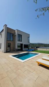 a house with a swimming pool in front of a house at MB Villas in Vrnjačka Banja