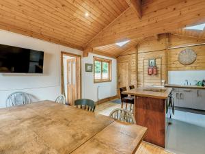 a kitchen and dining room of a wooden cabin at Mayfield Lodge - Uk39917 in Heckington