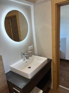 a bathroom with a white sink and a mirror at Haus Gruber in Altenmarkt im Pongau