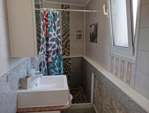 a bathroom with a sink and a shower at Athinas Art House in Kolymbia