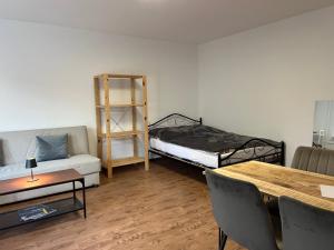 a room with a bed and a couch and a table at LuxusCityApartment in Berlin