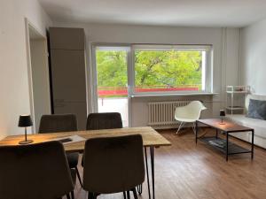 a living room with a table and chairs and a bed at LuxusCityApartment in Berlin +9 photos