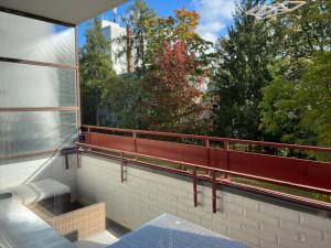 a balcony with a view of trees and a building at LuxusCityApartment in Berlin