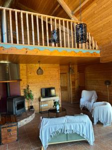 a living room with a staircase in a cabin at Grande maison en bois eco-responsable proche de la mer in Saint-Germain-sur-Ay