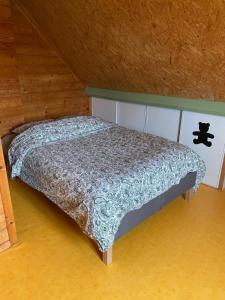 a bedroom with a bed in a attic at Grande maison en bois eco-responsable proche de la mer in Saint-Germain-sur-Ay +18 photos