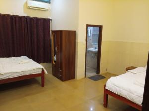 Ένα ή περισσότερα κρεβάτια σε δωμάτιο στο Blue Moon Hotel