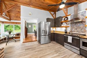 a kitchen with a stainless steel refrigerator and wooden ceilings at 1910 Asheville Gem in Fairview
