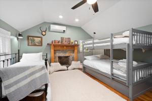 a bedroom with two bunk beds and a fireplace at 1910 Asheville Gem in Fairview