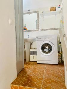 a washing machine in a bathroom with a sink at O Ninho in Mértola +5 photos