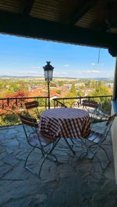a table and chairs on a patio with a view at Zum Waldschlössl im Vilstal in Aldersbach +3 photos
