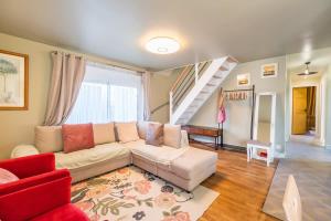 a living room with a white couch and a staircase at Maison familiale 8 personnes entre mer et campagne in Bégard +20 photos