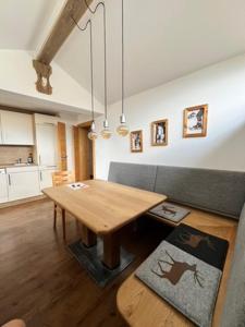 a living room with a wooden table and a couch at Haus Gruber in Altenmarkt im Pongau