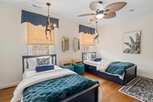 a bedroom with two beds and a ceiling fan at The Raleigh Resort House in Millbrook +66 photos