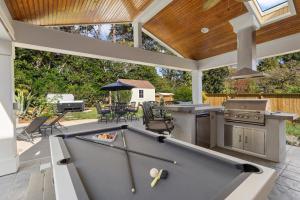 a pool table in the middle of a patio at The Raleigh Resort House in Millbrook