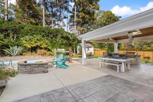 a patio with a pool table and a grill at The Raleigh Resort House in Millbrook