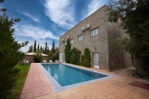 a house with a swimming pool in front of a building at Sakia Talamanzou in Talamennzou
