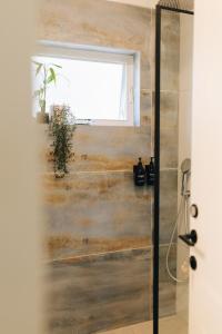 a bathroom with a shower and a window at Matar baYaar מטר ביער in El-Rom