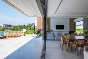 a dining room and living room with a table at Casa Golf in Camboriú