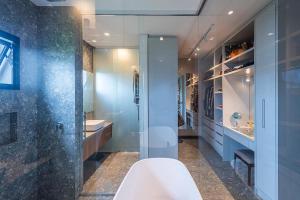 a bathroom with a tub and a shower and a sink at Casa Golf in Camboriú +16 photos