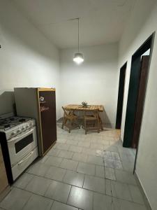 a kitchen with a stove and a table in it at Lumina in General Roca