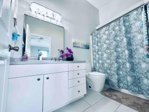 a bathroom with a shower with a toilet and a sink at Cape Coral Seascape in Cape Coral +37 photos