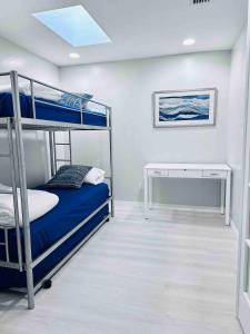 a bedroom with two bunk beds and a desk at Cape Coral Seascape in Cape Coral