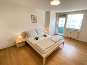 Postel nebo postele na pokoji v ubytování Ruhiges City Apartment mit Balkon - Wohlfühlen in Graz