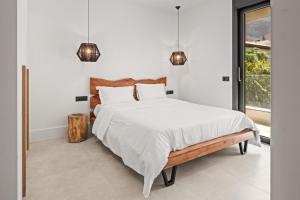 a bedroom with a large bed and a window at Serenity Blue Luxury Villa 7 Bedrooms in Koutouloufari +67 photos