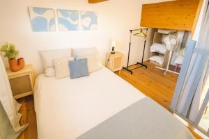 a bedroom with a large white bed with white pillows at Blue Beach La Ciotat in La Ciotat