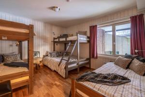 a bedroom with two bunk beds and a window at Large Ski in-Ski out Apartment for Groups in Hemsedal