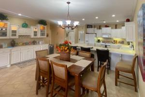 a kitchen with a table and chairs and a kitchen with white cabinets at Central Terrace Retreat in Hot Springs