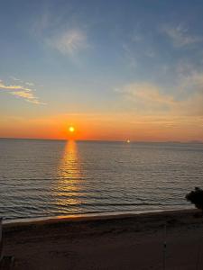 a sunset over the ocean with the sun setting at Holiday apartaments Gaca in Lezhë