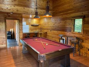 a pool table in a room with wooden walls at A Hikers Dream - 34 Acres Hot Tub Views Trails in Cosby