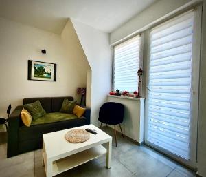 a living room with a couch and a table at Zmaj 16 in Divčibare
