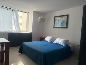 Ένα ή περισσότερα κρεβάτια σε δωμάτιο στο Lindo apartamento de 3 alcobas y de dos cómodo para una linda estadía en Cartagena