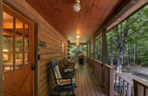 a porch of a cabin with chairs on it at 4BR Mountain retreat with Ski Base Bikes & Yard in Bartlett