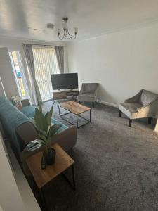 a living room with a couch and a table at Northumberland Stay in Widdrington