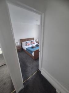 a bedroom with a bed with pillows on it at Northumberland Stay in Widdrington