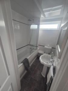 a bathroom with a tub and a toilet and a sink at Northumberland Stay in Widdrington