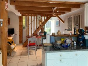 a kitchen with a table and a counter top at Gite les cèdres in Saint-Priest