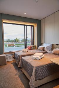 a bedroom with three beds and a large window at Keruen inn Merke in Aktokan