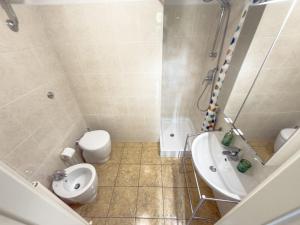 a bathroom with a toilet and a sink at Viale Volta Authentic Apartment in Florence +26 photos