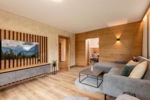 a living room with a couch and a table at Apart Garber in Zellbergeben