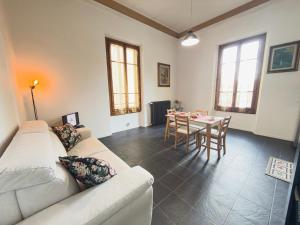 a living room with a couch and a table at Viale Volta Authentic Apartment in Florence